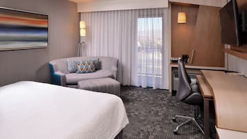 Premium bedding, desk, laptop workspace, blackout curtains