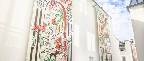 A building with colorful murals on its exterior walls.