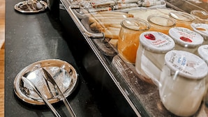 A buffet area with various food items and condiments. - Maison Mère (Paris)