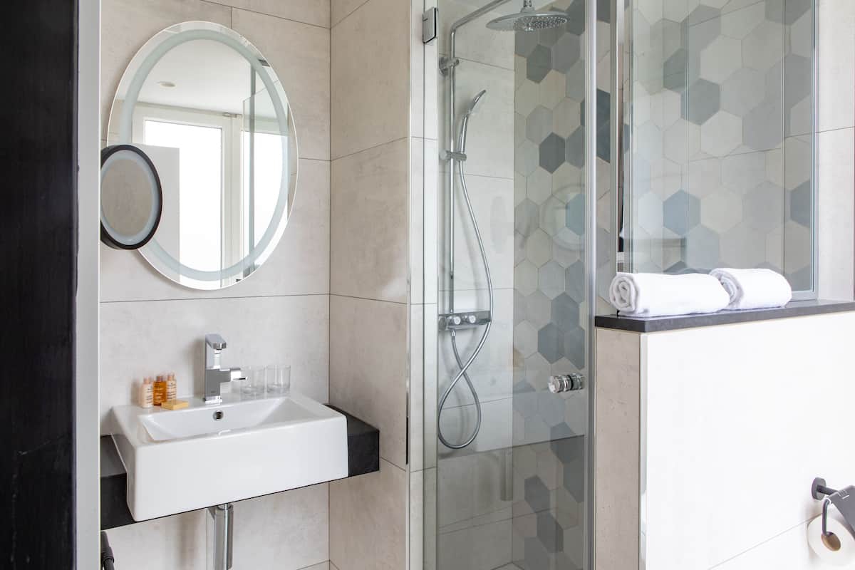 designer toiletries, hair dryer, slippers, towels
