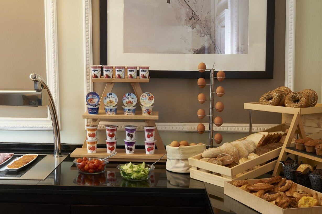 A breakfast buffet with various food items and a coffee machine.