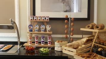 A breakfast buffet with various food items and a coffee machine.