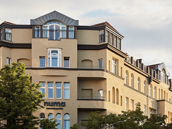 A multi-story building with a beige facade, large windows, and balconies. - Numa Berlin Novela (Berlin)