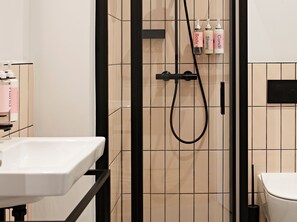 Shower, designer toiletries, hair dryer, towels