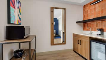 A compact kitchen with a microwave, a sink, and a refrigerator.