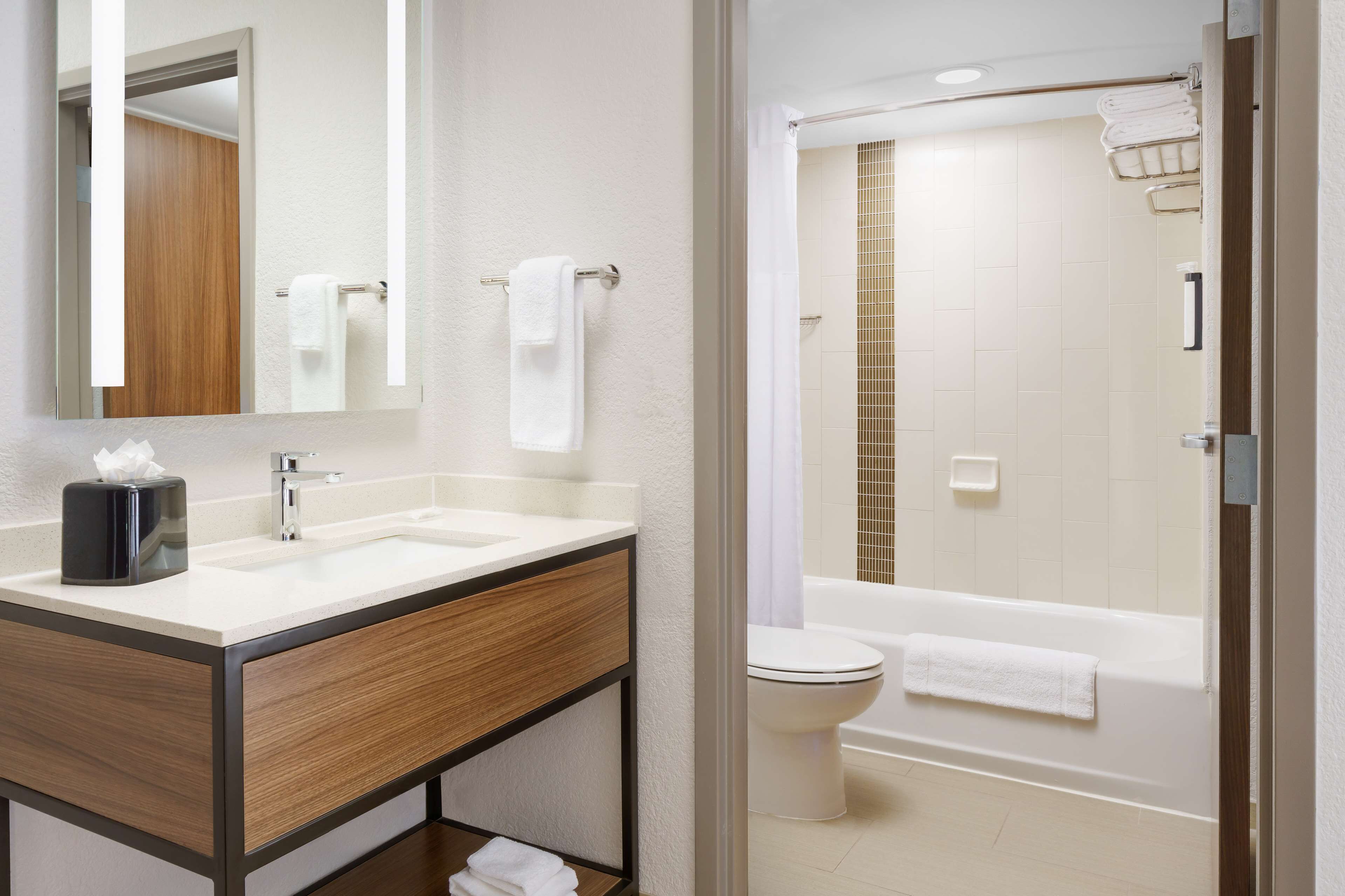 designer toiletries, hair dryer, towels