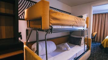 A bunk bed room with a wooden headboard, a desk, and a chair.