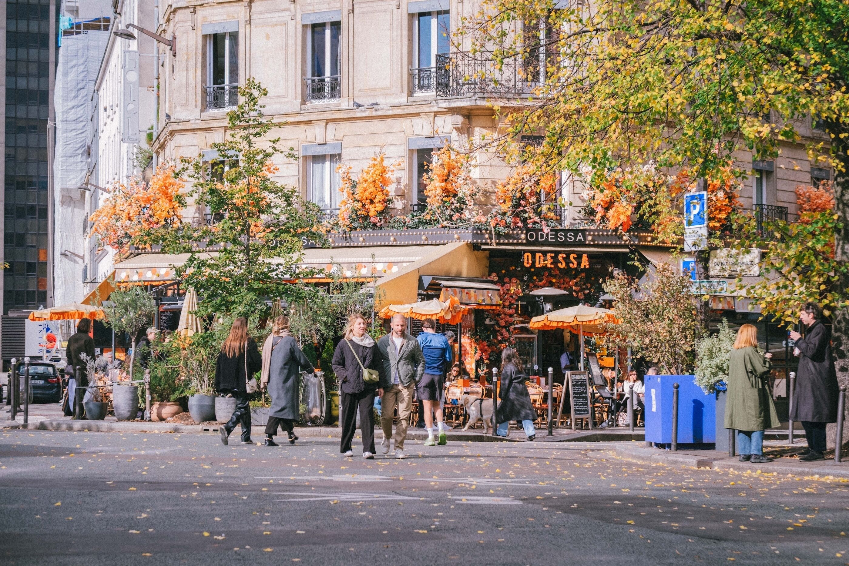 A street scene with a building labeled 'ODESSA' and outdoor seating.