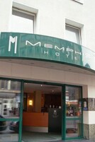 L'ingresso di un hotel con una reception e una porta in vetro.