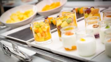 A tray of fruit parfaits and yogurt parfaits on a table.