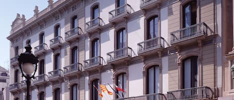 A historic building with multiple balconies and a central entrance.