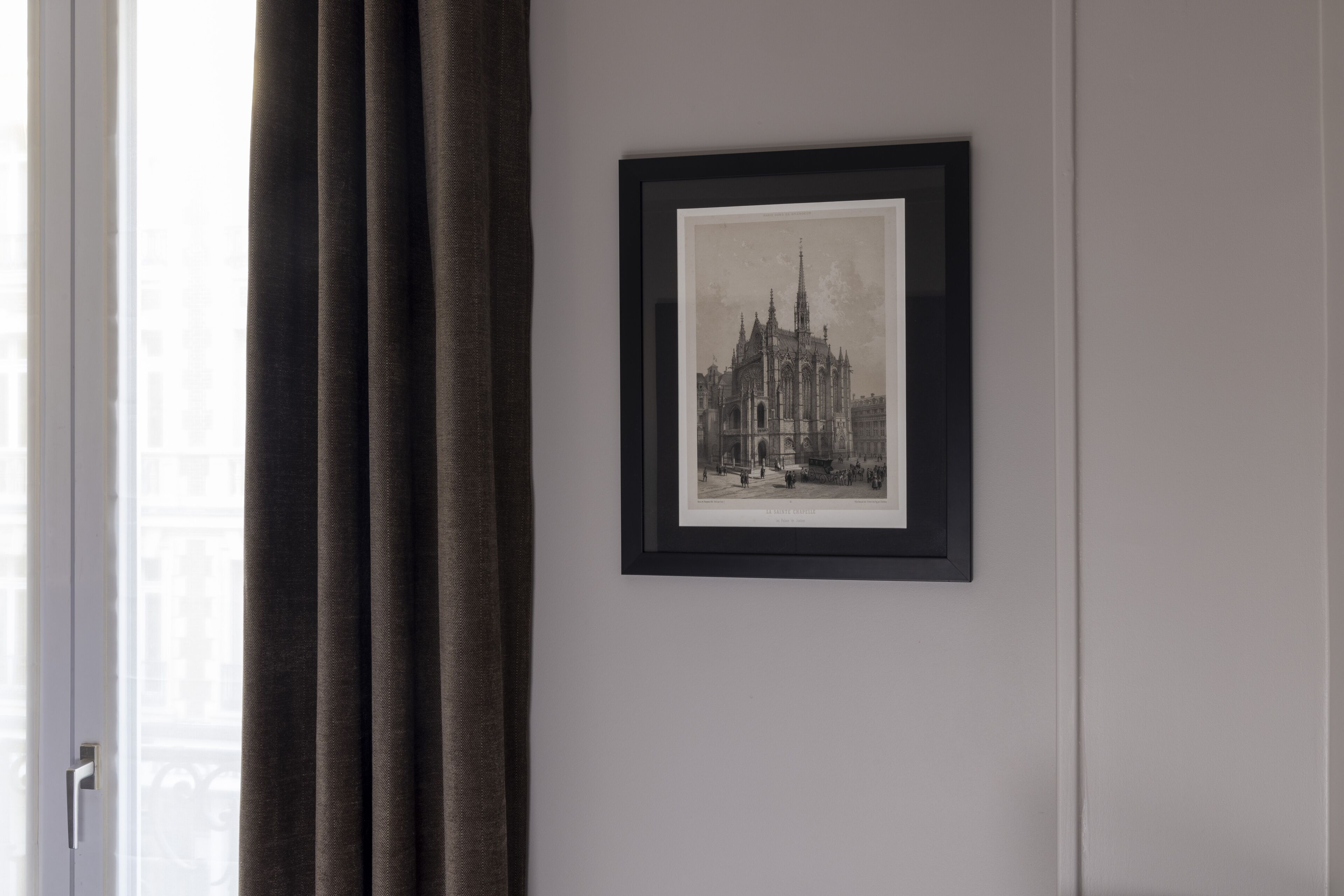 A framed black and white photograph of a cathedral on a wall.