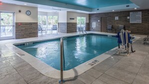 An indoor swimming pool with a 3 FT depth, a clock, and a 'No Diving' sign.