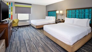 A hotel room with two beds, a desk with a TV, a chair, and a window with a view. - Hampton Inn Daytona/Ormond Beach (Ormond Beach)