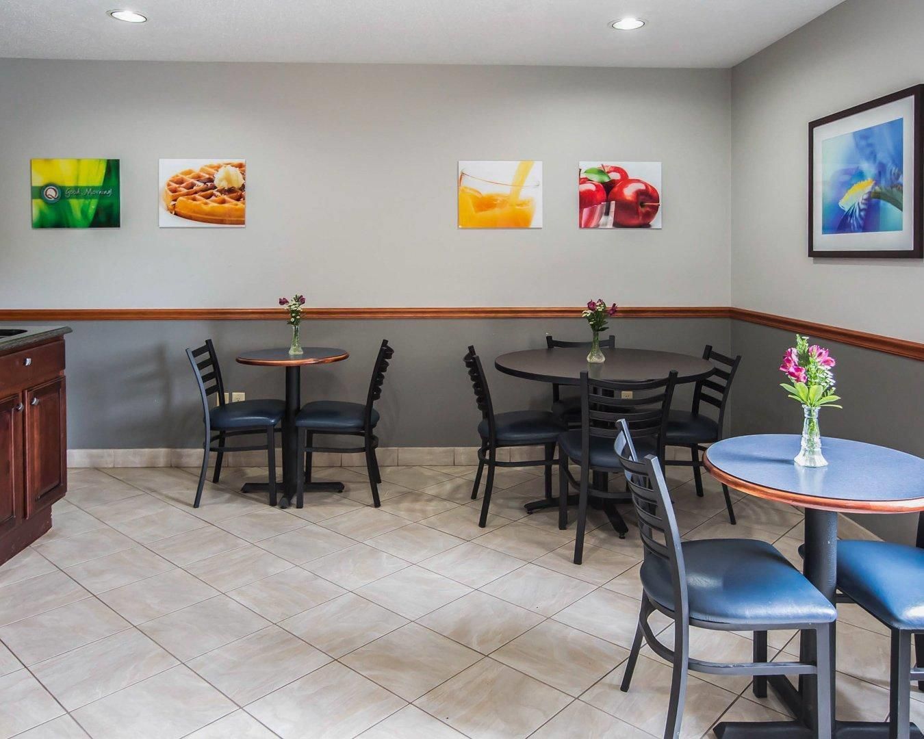 A restaurant with a breakfast menu, a fruit display, and a flower vase.