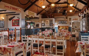 A cozy restaurant with wooden furniture, a bar area, and various decorations including a bicycle and lanterns. - Fitzgerald's Woodlands House Hotel (Adare)