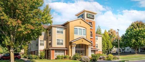 A Stay America hotel with a lobby entrance, multiple floors, and a parking area.