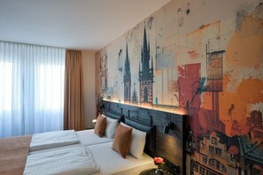 A hotel room with a large bed, a headboard with a cityscape mural, and a window with sheer curtains. - Hotel Miramar Frankfurt City Centre (Frankfurt)
