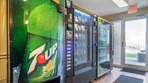 A 7UP vending machine and a refrigerator vending machine in a lobby area. - Extended Stay America Suites Indianapolis Northwest I465 (Indianapolis)