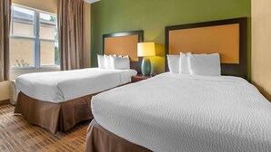 A hotel room with two beds, a window with curtains, a lamp, and a view of the outside. - Extended Stay America Suites Indianapolis Northwest I465 (Indianapolis)