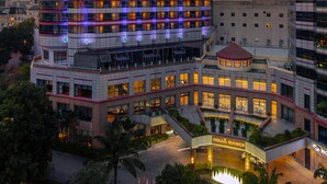A modern hotel with a prominent "MELIA" sign, featuring a multi-story structure with numerous windows and a well-lit entrance area. - Melia Hanoi (Hanoi)