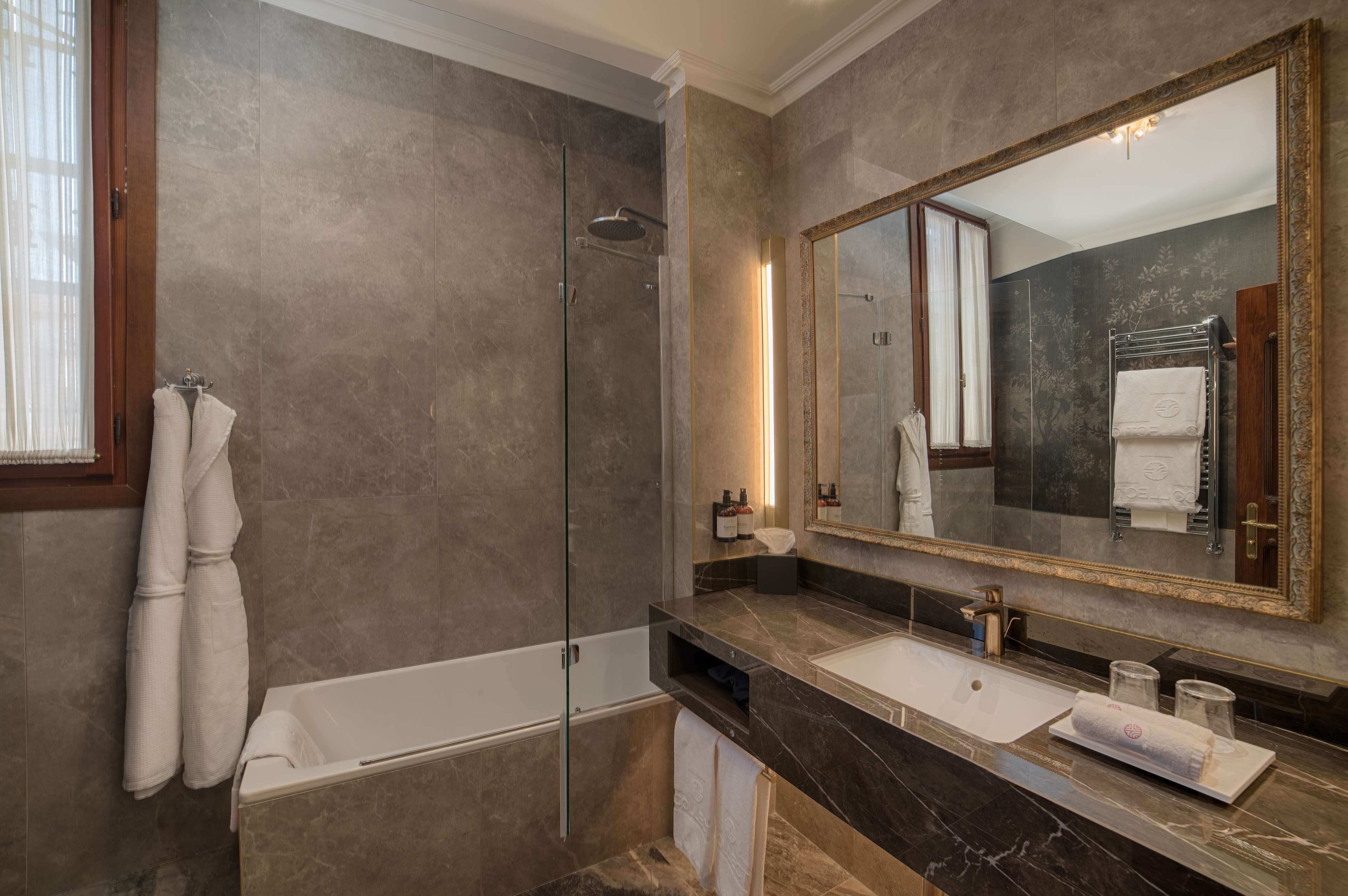 rainfall showerhead, designer toiletries, hair dryer, bathrobes