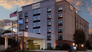 A Fairfield Inn & Suites by Marriott hotel with a brick facade, multiple windows, and a well-lit entrance. - Fairfield Inn & Suites by Marriott Charleston (South Charleston)