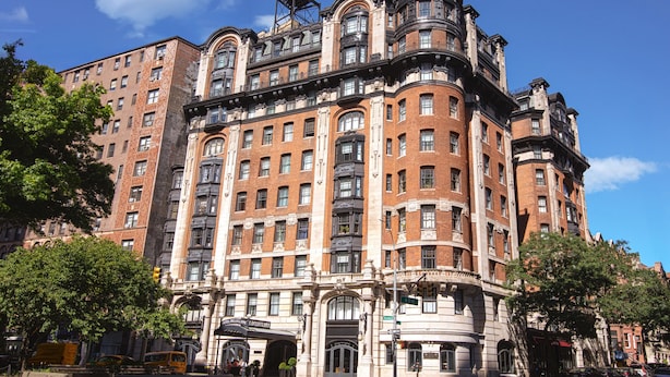 A historic building with multiple floors, large windows, and a prominent corner entrance.