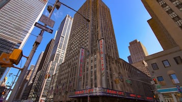 A tall building with a large sign reading "Radio City Music Hall" at the top.