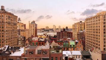 A dense urban area with a variety of building styles and a river in the background.