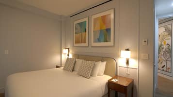 A hotel room with a large bed, two bedside lamps, and two abstract paintings on the wall.