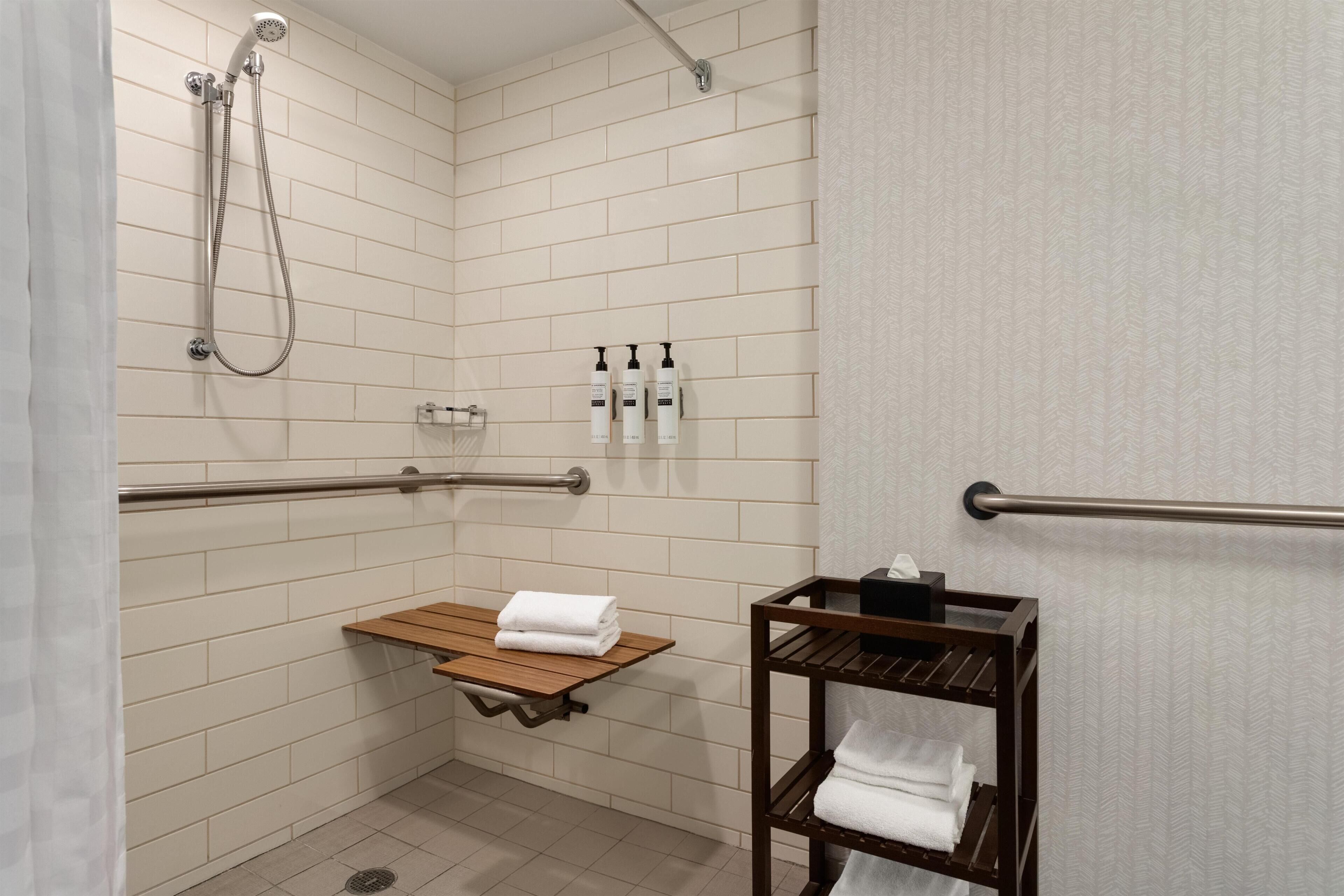 Suite, One King Bed, Roll In Shower | Bathroom | Free toiletries, hair dryer, towels