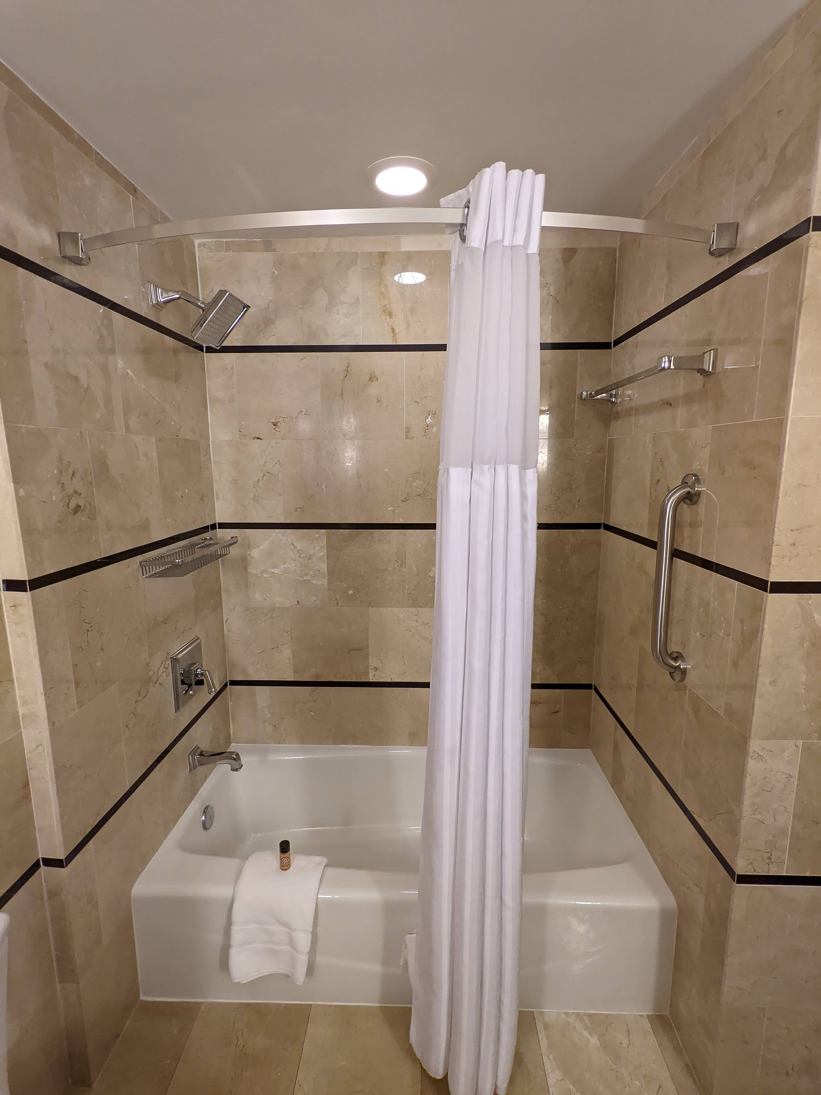 combined shower/bathtub, designer toiletries, hair dryer, towels