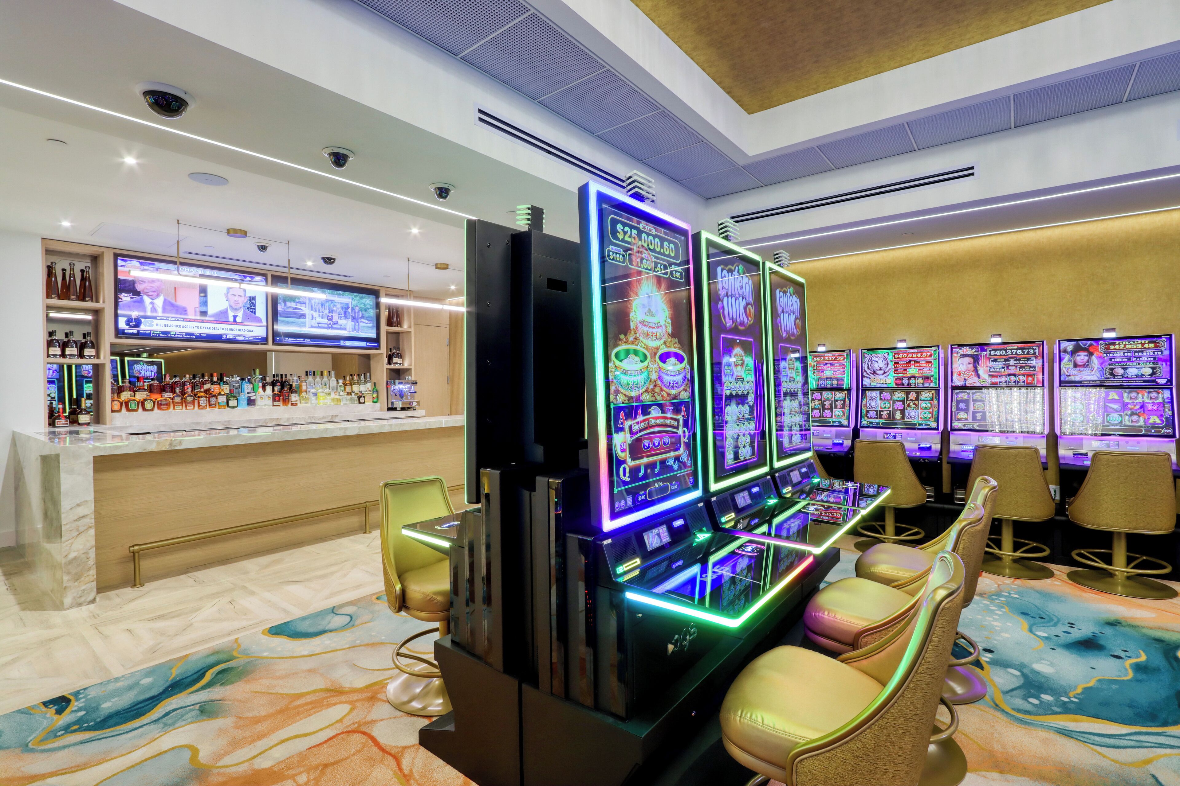 A casino area with slot machines, a bar, and comfortable seating.