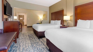 A hotel room with two beds, a desk, a television, and a lamp. - Comfort Suites Keeneland (Lexington)
