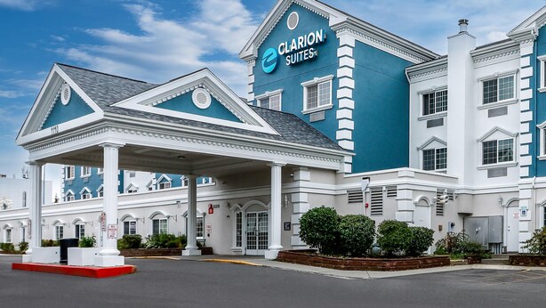 A hotel with a prominent 'Clarion Suites' sign, a covered entrance, and a classic architectural style. - Clarion Suites Anchorage Downtown (Anchorage)