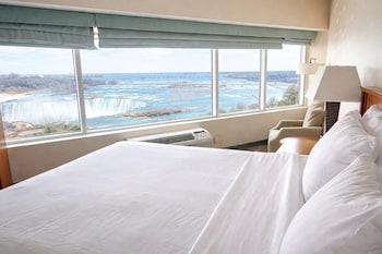 Standard Room, 1 King Bed, Jetted Tub (Falls View) | Desk, blackout drapes, iron/ironing board, free cribs/infant beds at Niagara Fallsview Hotel