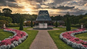 A garden with a central fountain, surrounded by a paved walkway and flower beds. - Niagara Fallsview Hotel (Niagara Falls)