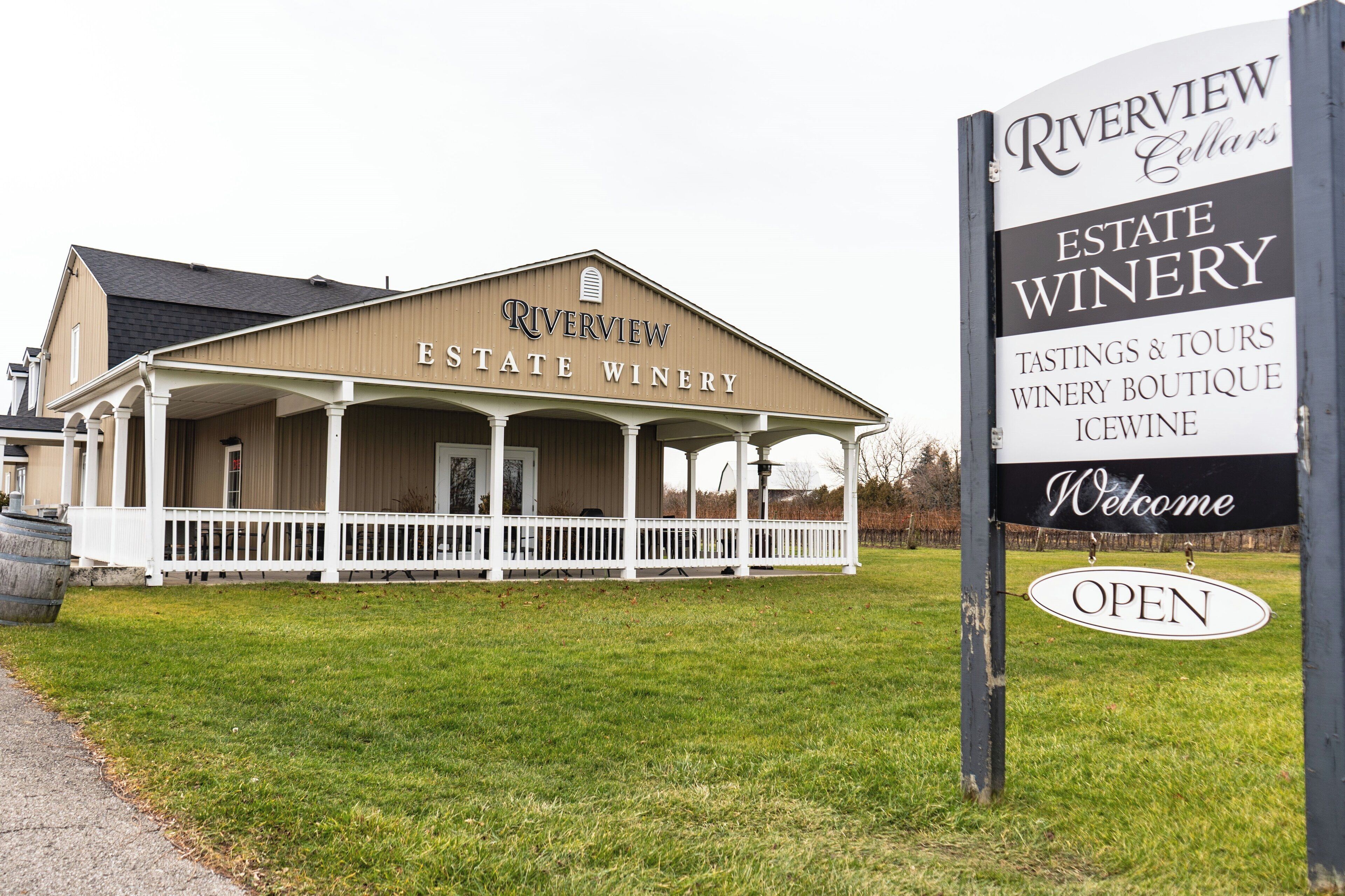 Riverview Estate Winery with a covered porch and a signboard indicating it offers tastings, tours, a winery boutique, and icewine.