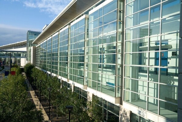 A modern building with large glass windows and a covered walkway. - Holiday Inn & Suites Chicago - Downtown by IHG (Chicago)
