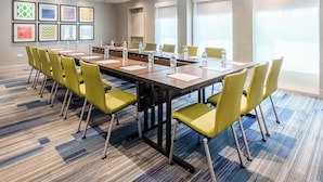 A conference room with a long table, yellow chairs, and water bottles. - Holiday Inn Express Hotel & Suites Chicago-Midway Airport by IHG (Chicago)