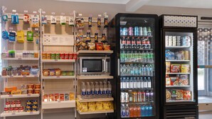 A vending area with snacks, drinks, and microwaves.