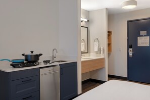 A compact kitchen with a stove, sink, and dishwasher. - Spark by Hilton West Coxsackie (West Coxsackie)