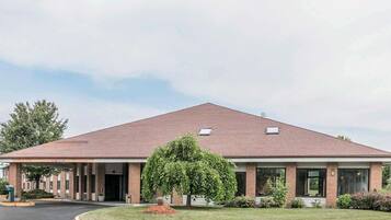 A two-story building with a flat roof and brick facade.
