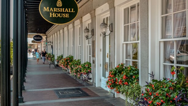 A corridor with a row of windows and a sign for 'Marshall House'. - The Marshall House, Historic Inns of Savannah (Savannah)