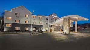 A Fairfield Inn & Suites by Marriott hotel with a modern design, featuring a spacious entrance and a well-lit facade.