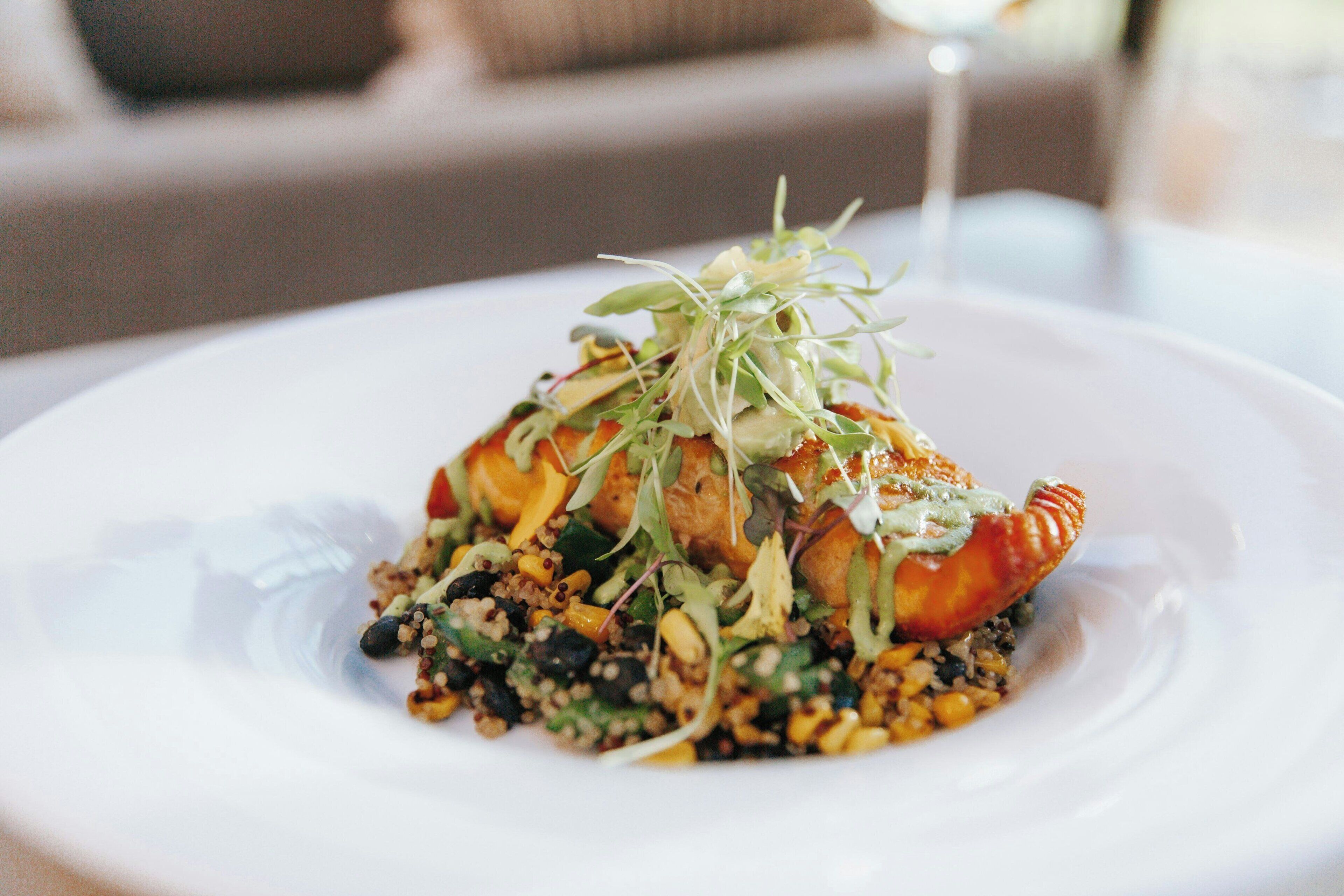 A plate of food with a variety of ingredients and garnishes.