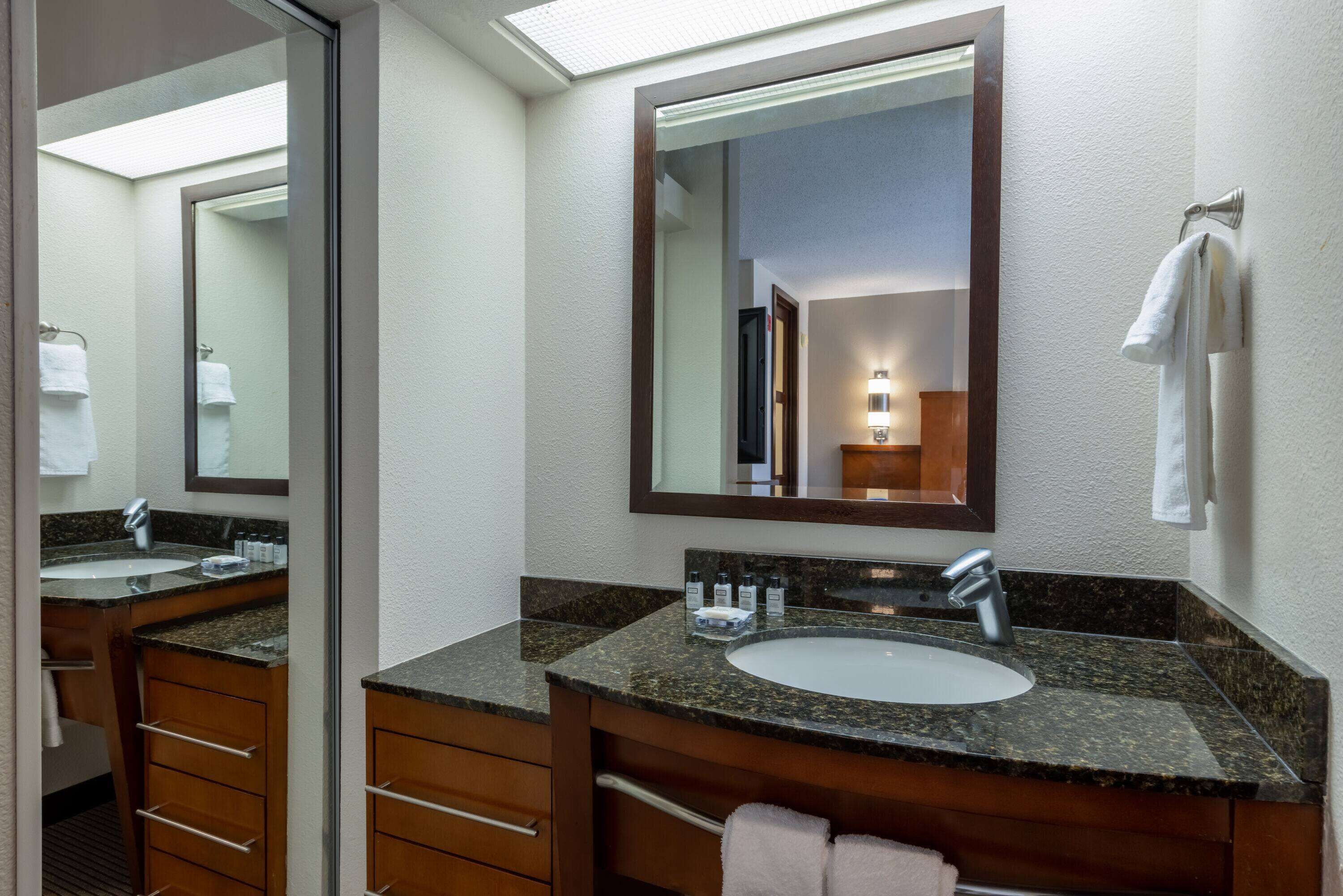 combined shower/bathtub, designer toiletries, hair dryer, towels