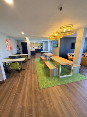A modern interior with a dining area, kitchen, and seating space.