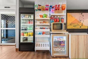 A vending area with snacks, beverages, and a microwave. - Spark by Hilton Appleton (Appleton)